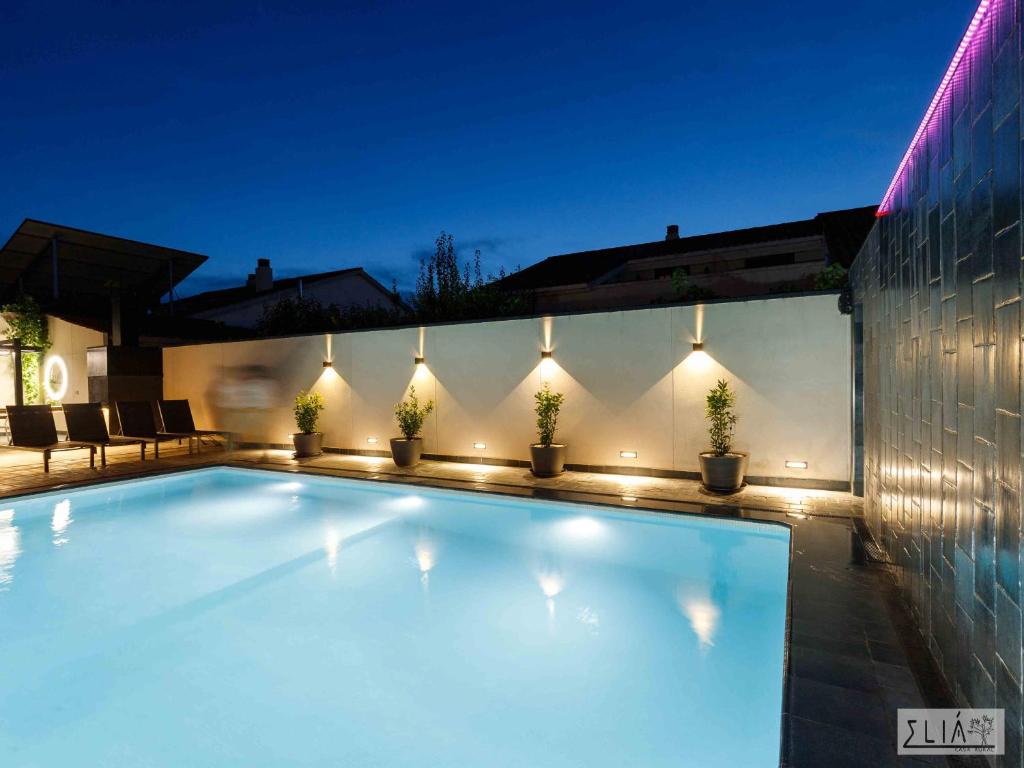 a swimming pool with lights on the side of a house at Villa Eliá in Arcas