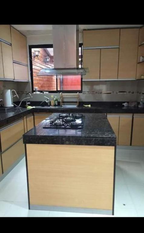 a kitchen with a stove and a counter top at La casita de Vale in Tarapoto