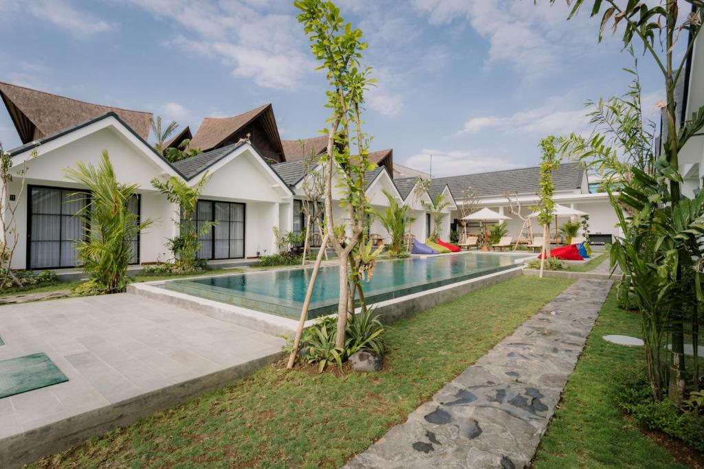 an exterior view of a villa with a swimming pool at Sari Uma Canggu By Hospitality Bali in Canggu