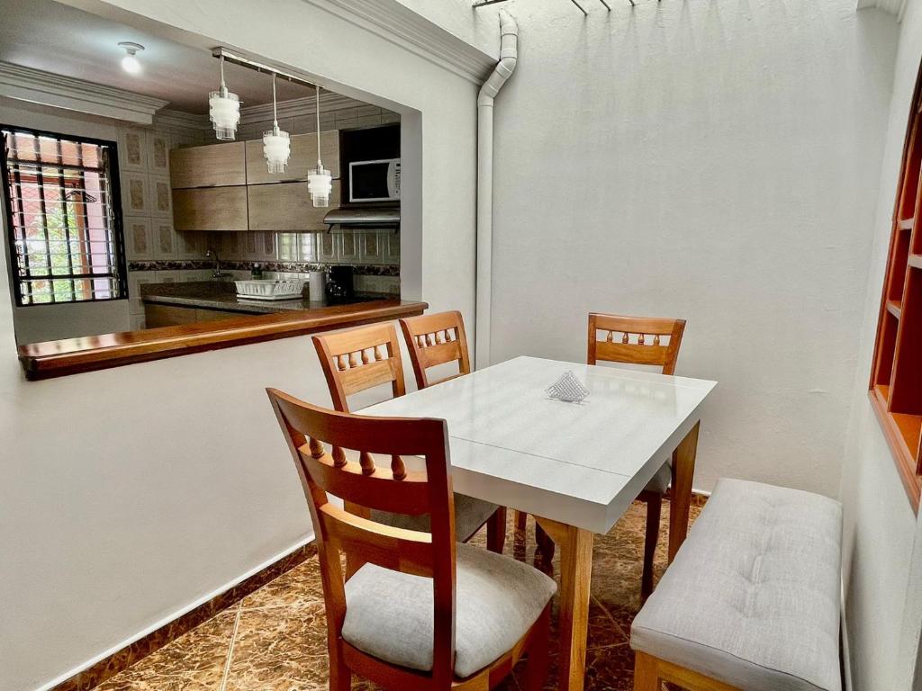 a kitchen and dining room with a white table and chairs at Best Location near Mayorca Mall Up to 10 guest in Sabaneta