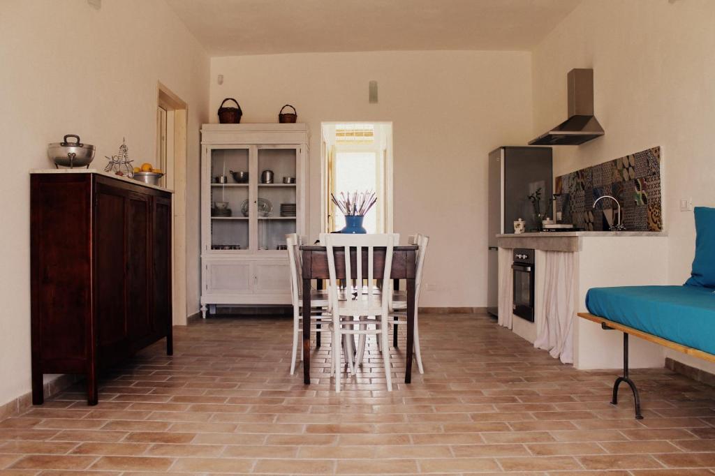 una cucina con tavolo e sedie in una stanza di Casa Vacanza Vendicari a Noto Marina