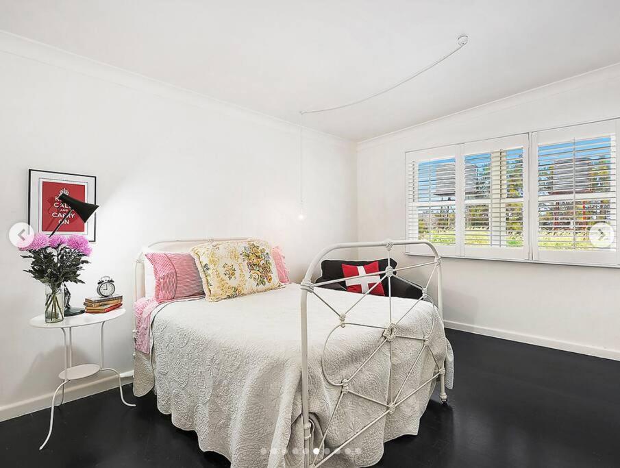 a white bedroom with a bed and a window at Trelawney Farm Mudgee - Rural retreat in Mudgee