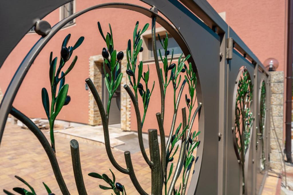 a gate with a cactus in front of a building at LASKARA Garden Apartment by Prague Forest in Nové Jirny