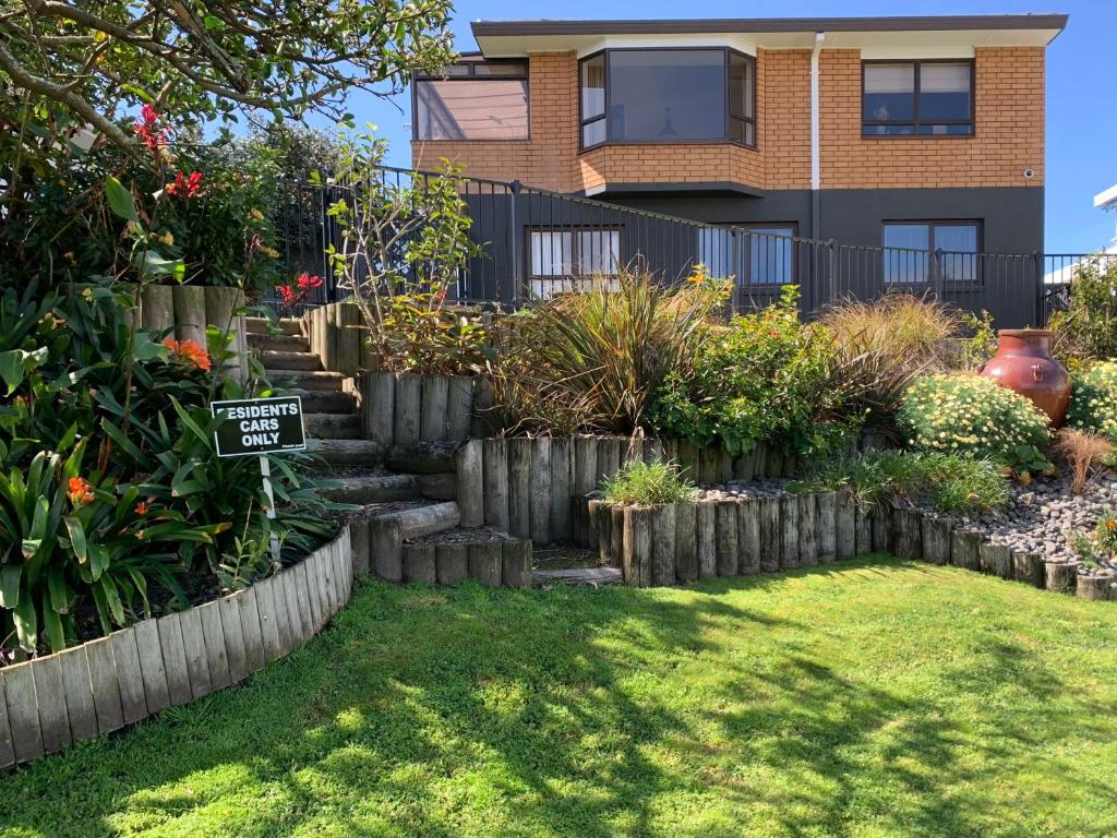 a garden in front of a house at Vicroad The Mount in Mount Maunganui
