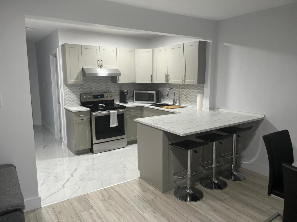 a kitchen with an island in the middle of it at Casa LACK - Tranquila Suites 3 in Ottawa