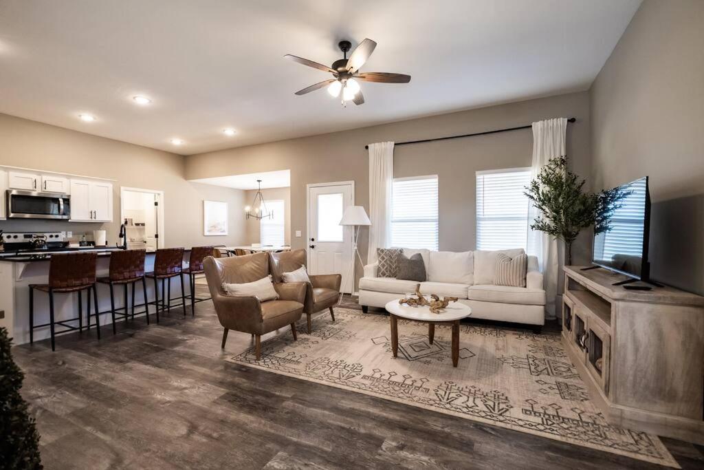 a living room with a couch and a table at NEW! Beautiful and Spacious Home in Ozark