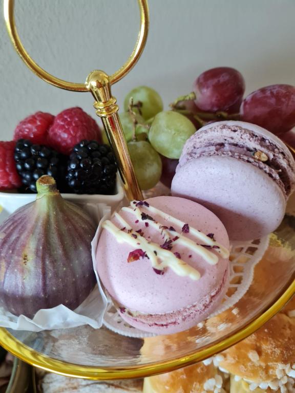 a plate of food with a pink dessert and fruit at Your little sparkle Room "FOR WOMAN ONLY !" in Vienna