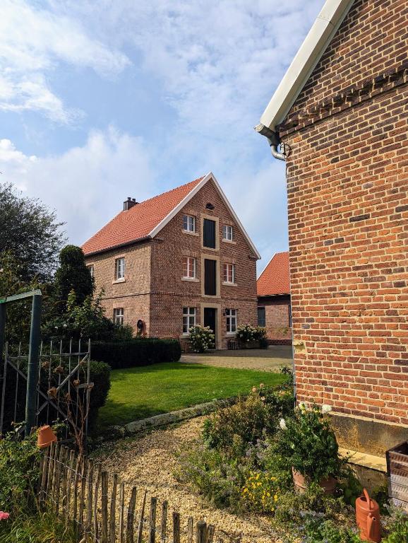 a large brick house with a fence in front of it at Alter Kornspeicher im Münsterland in Greven