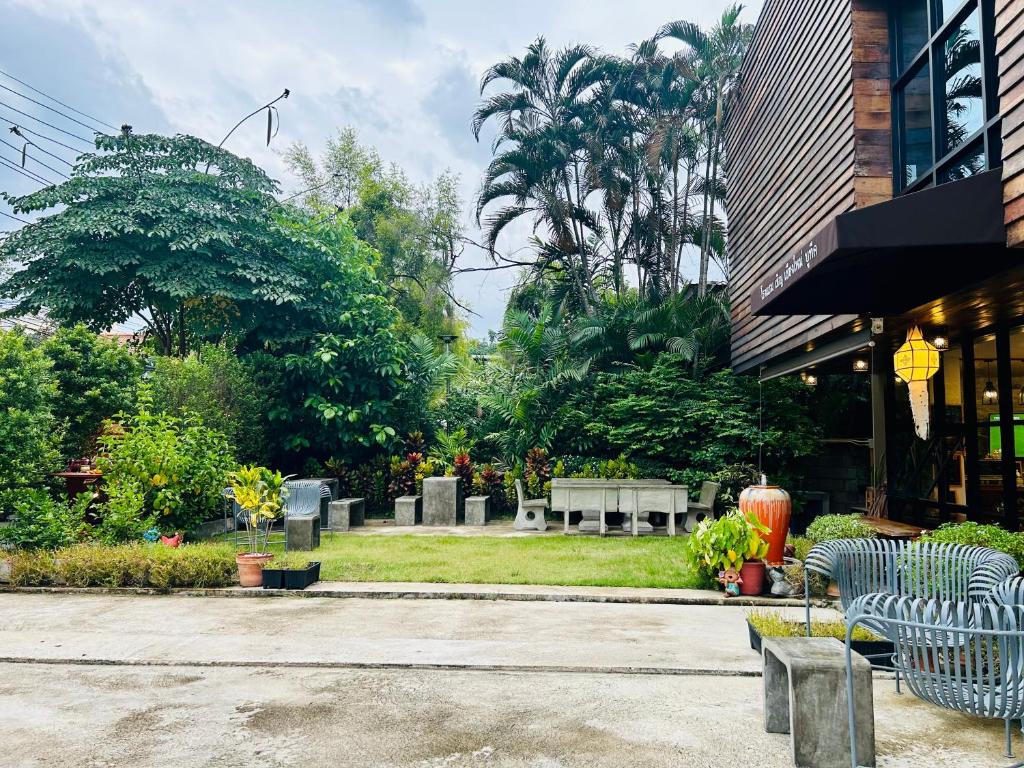 a group of benches sitting outside of a building at Chern Chiangmai Boutique Hotel in Chiang Mai