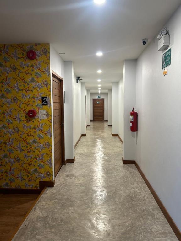 a hallway with a long corridor with a fire hydrant in a building at Chern Chiangmai Boutique Hotel in Chiang Mai
