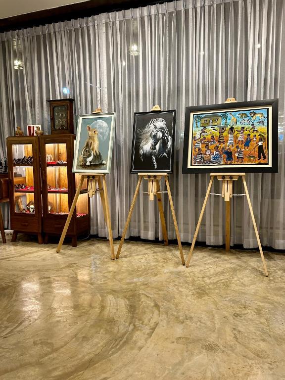 a group of framed pictures on stands in a room at Chern Chiangmai Boutique Hotel in Chiang Mai