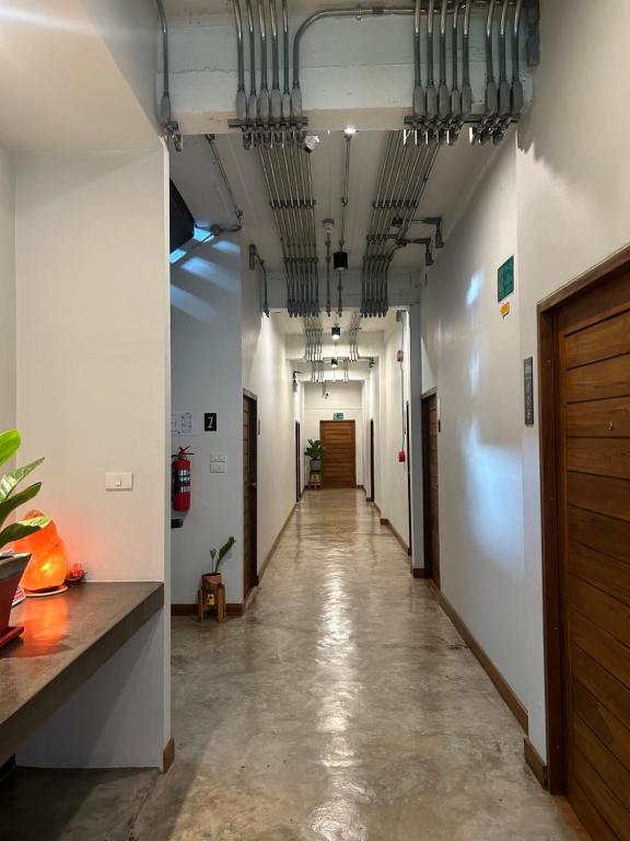 a corridor of an office with a long hallway at Chern Chiangmai Boutique Hotel in Chiang Mai