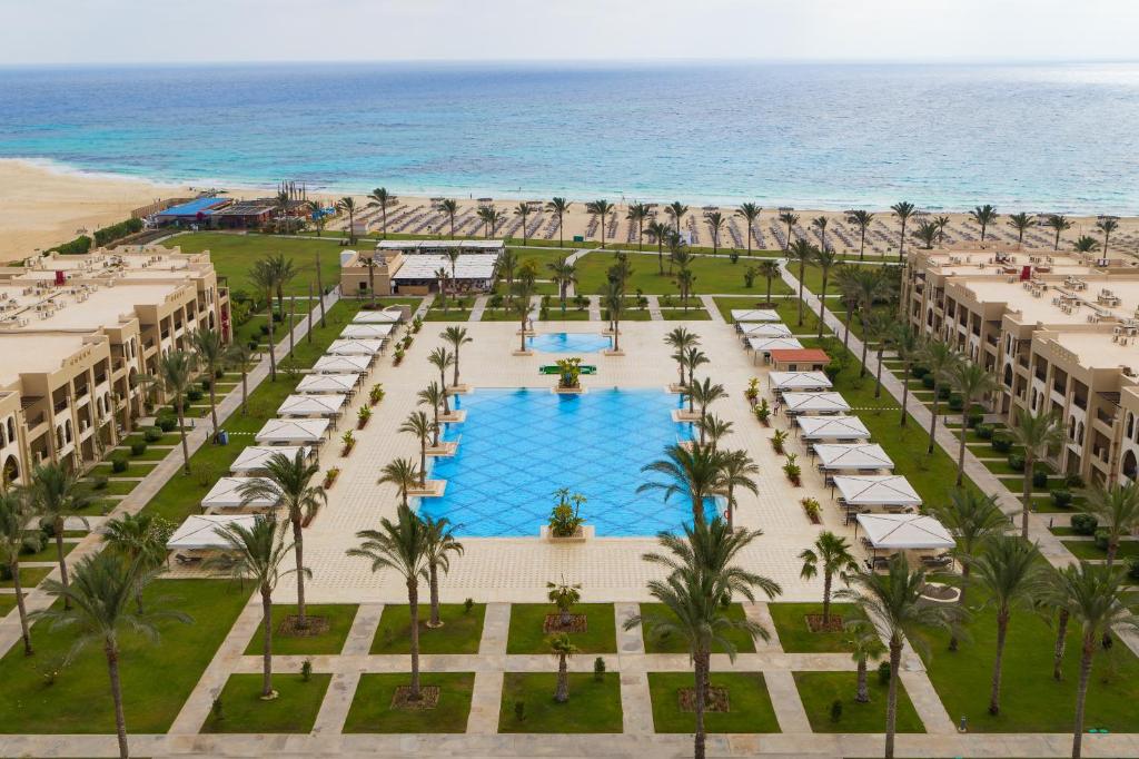 an aerial view of a resort with a pool and the beach at Jaz Oriental, Almaza Bay in Marsa Matruh