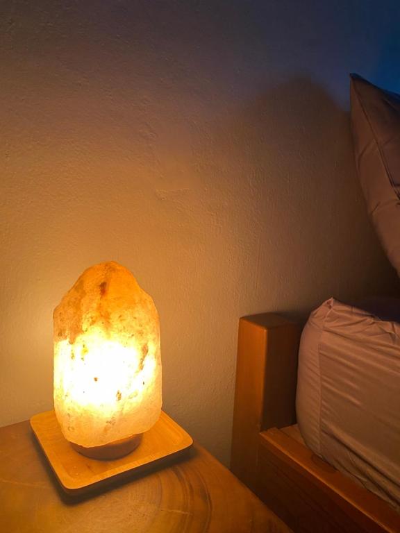a lamp sitting on a table next to a bed at Chern Chiangmai Boutique Hotel in Chiang Mai