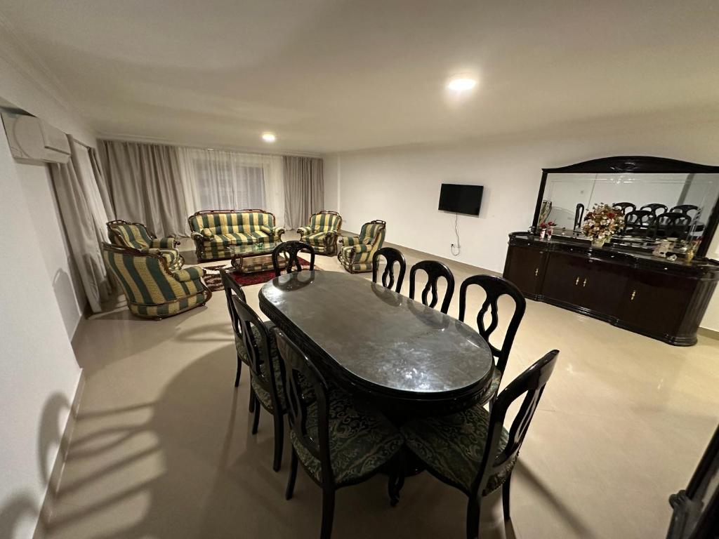 a living room with a dining room table and chairs at Queen plaza Nasr City in Cairo