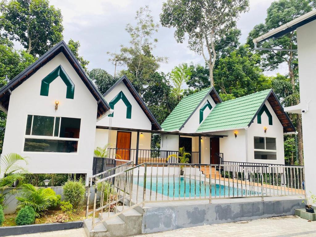 a house with a green roof at Regalia Wayanad in Kalpetta