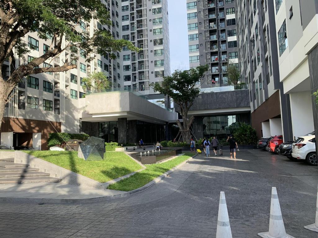 a street with white cones in a city with tall buildings at The Base Central Pattaya by Adam in Pattaya