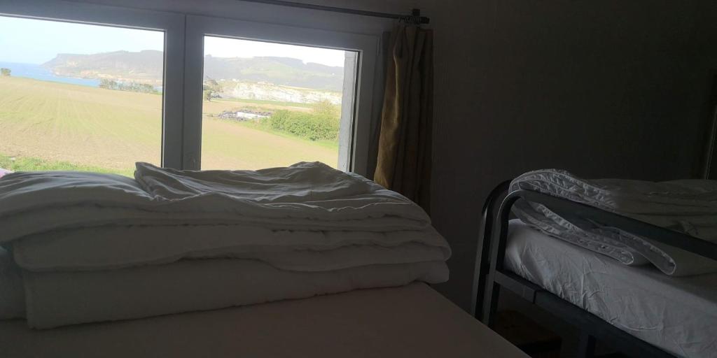 Postel nebo postele na pokoji v ubytování Langre Wayve House