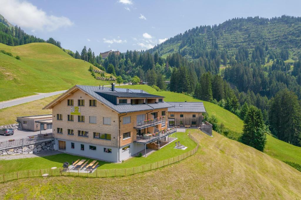 an aerial view of a house on a hill at Hus23 in Schröcken