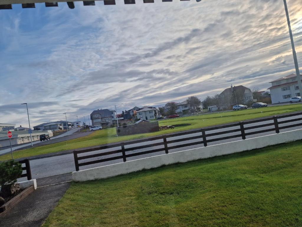 a fence on the side of a road at Sól - S12 guesthouse in Keflavík