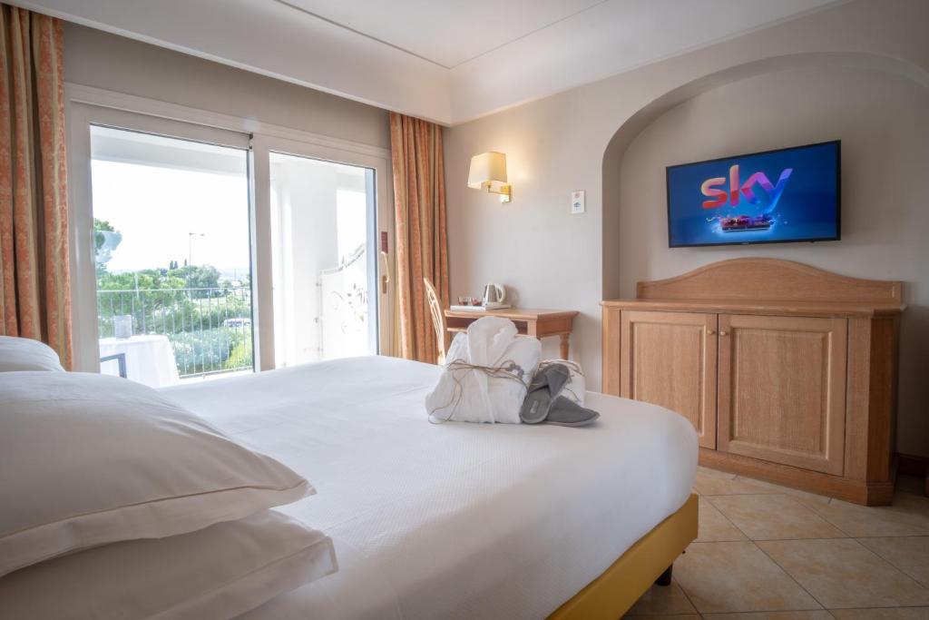 Postel nebo postele na pokoji v ubytování Palace Hotel Desenzano