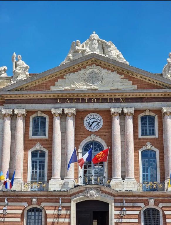 a building with a clock on the front of it at Le Duplex au centre de Toulouse - Self check In in Toulouse
