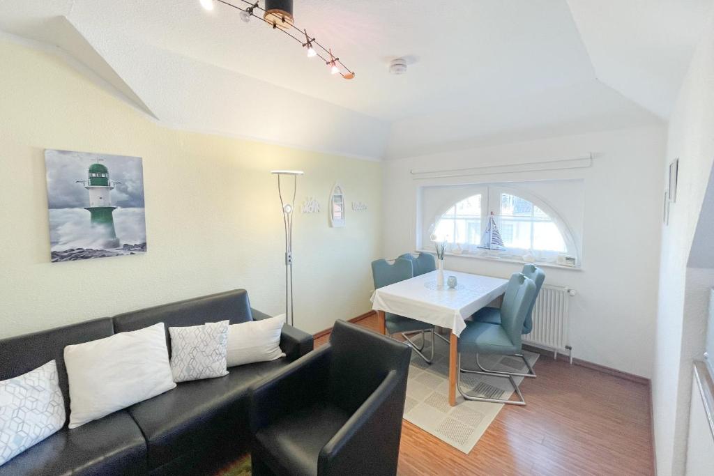 a living room with a couch and a table at Maria Gabriele Karlstrasse 6b Ferienwohnung 12 in Kolpinsee