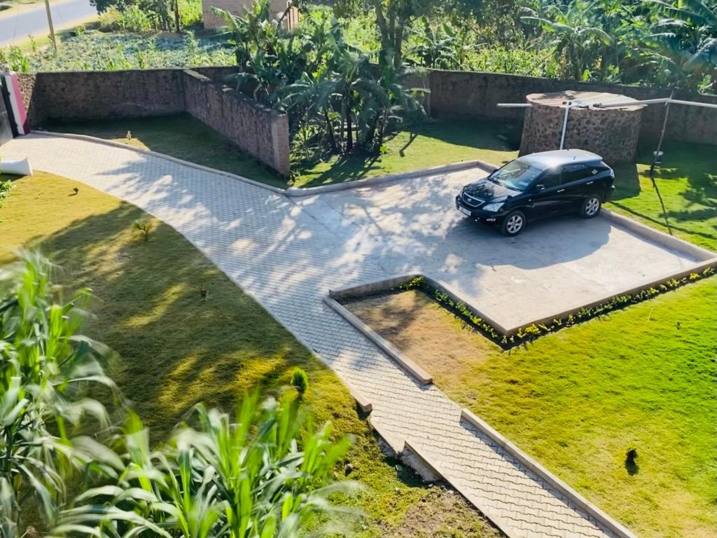 a black car parked in a parking lot at Pearl Sanctuary 02_Kisoro Homestay in Kisoro