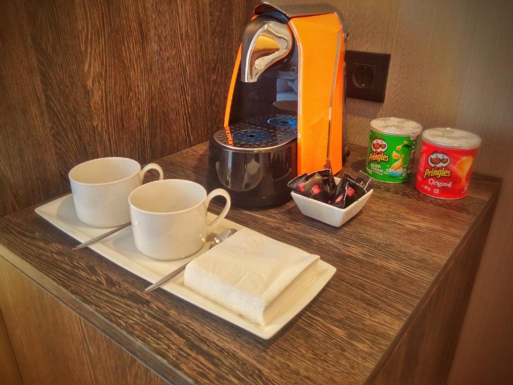 a table with two cups and a plate of food at MB Boutique Hotel - Adults Recommended in Nerja