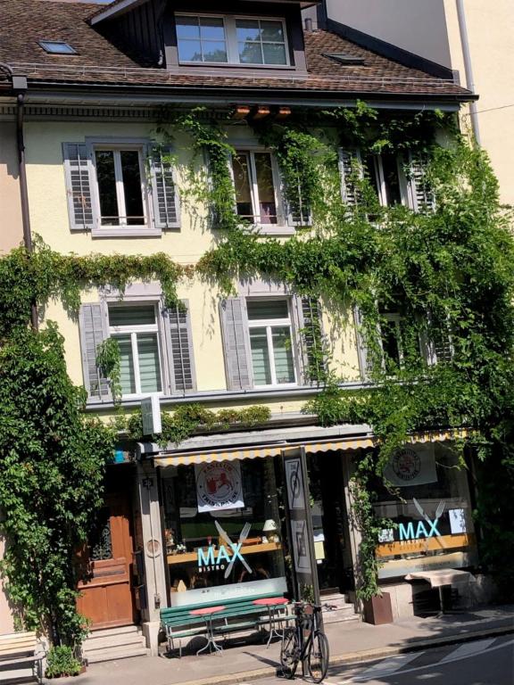 a store with a bench in front of a building at B&B Winterthur in Winterthur