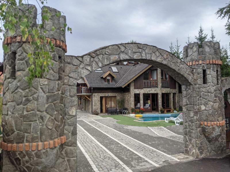 a stone house with an archway in front of it at Vila Zlatibor in Zlatibor