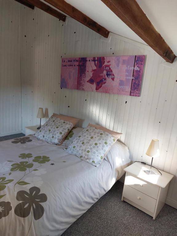 a bedroom with a bed with two pillows on it at La Quiétude in Cotignac