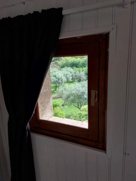 a window in a room with a curtain at La Quiétude in Cotignac