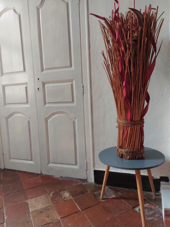 a vase sitting on a table next to a door at La Quiétude in Cotignac