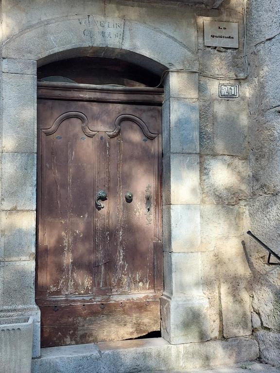 a large wooden door on the side of a building at La Quiétude in Cotignac