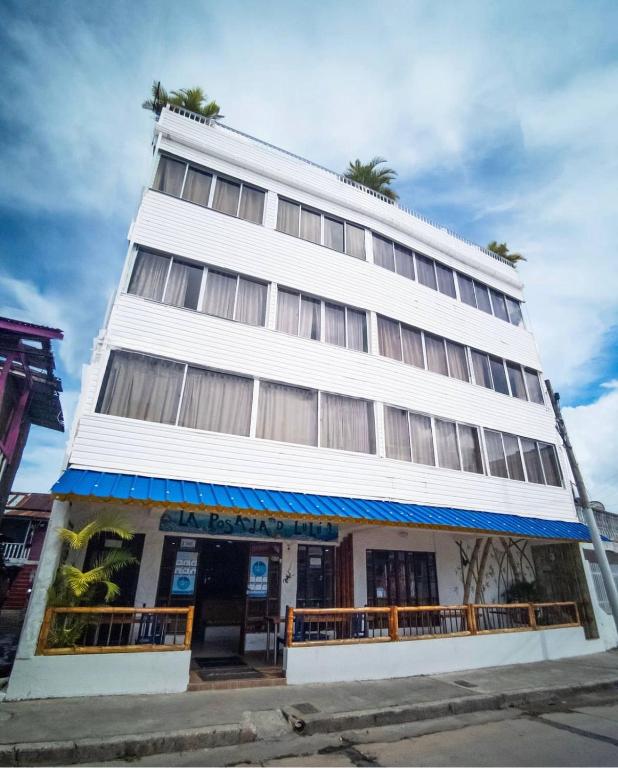 a tall white building with trees on top of it at La Posada De Lulú in San Andrés