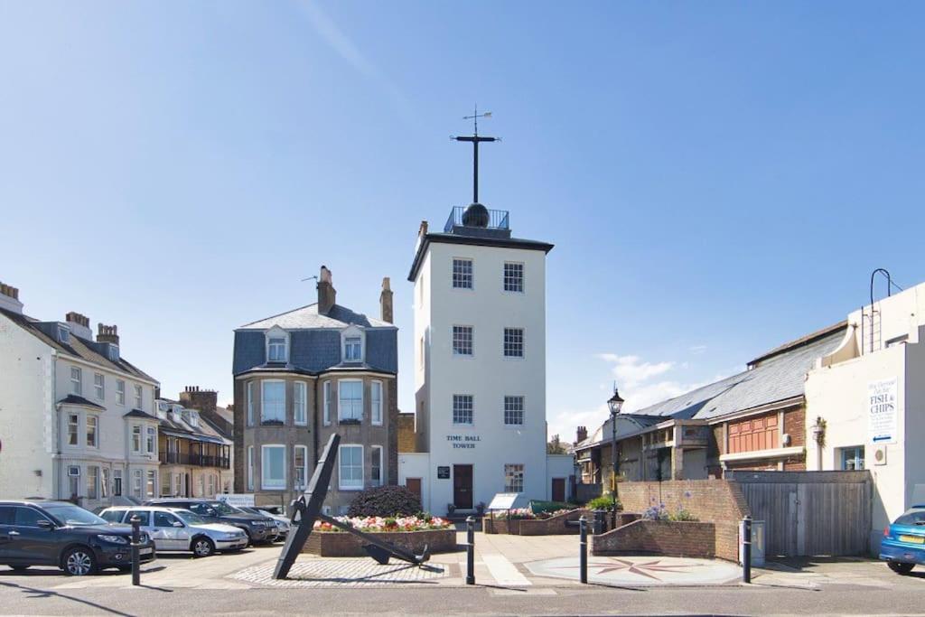 a white building with a cross on top of it at Stylish beachfront apartment in historic Deal in Kent