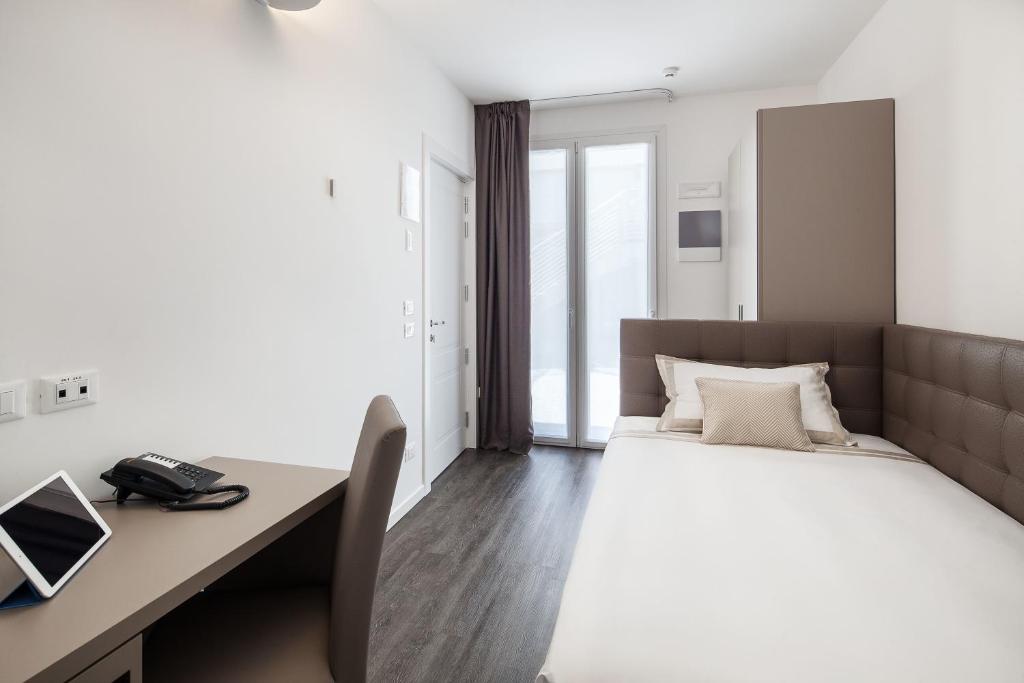 Posteľ alebo postele v izbe v ubytovaní Hotel Studio Inn Centrale & Milano Urban Padel