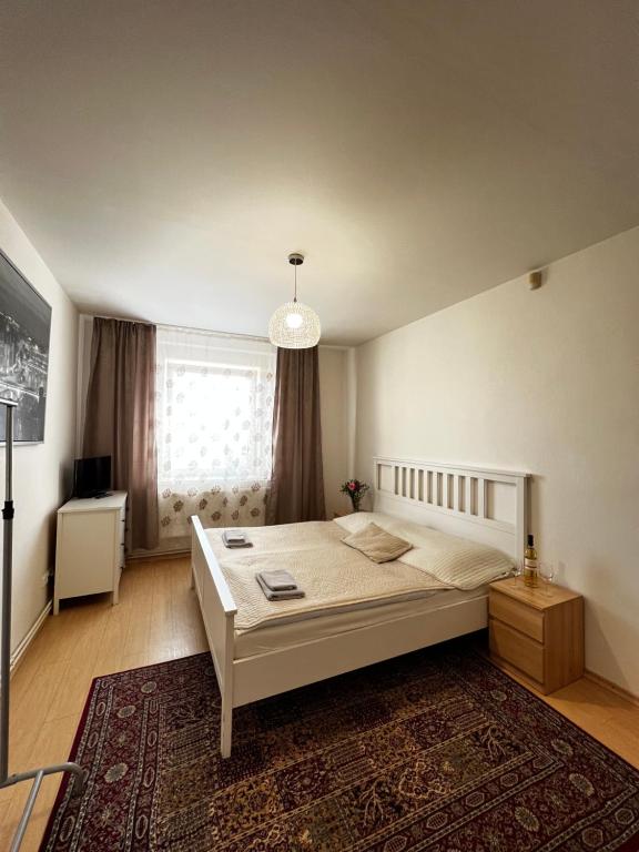 a bedroom with a large white bed and a window at Penzion Sofi in Prague