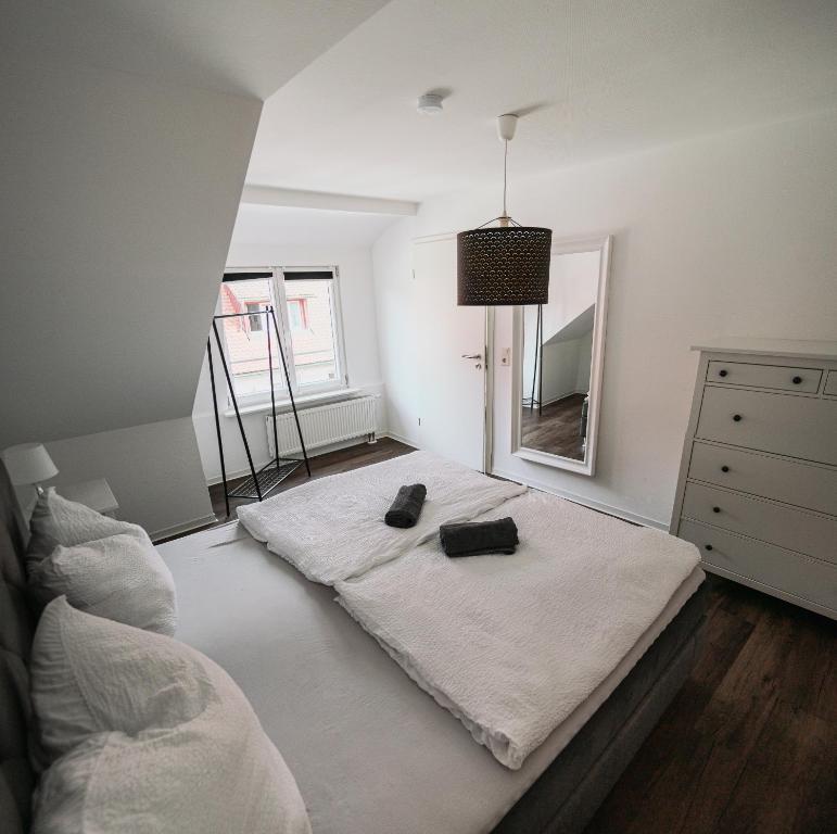 a bedroom with a bed with two bags on it at B&B Ferienwohnung mit bester Aussicht/Lage in Wangen im Allgäu
