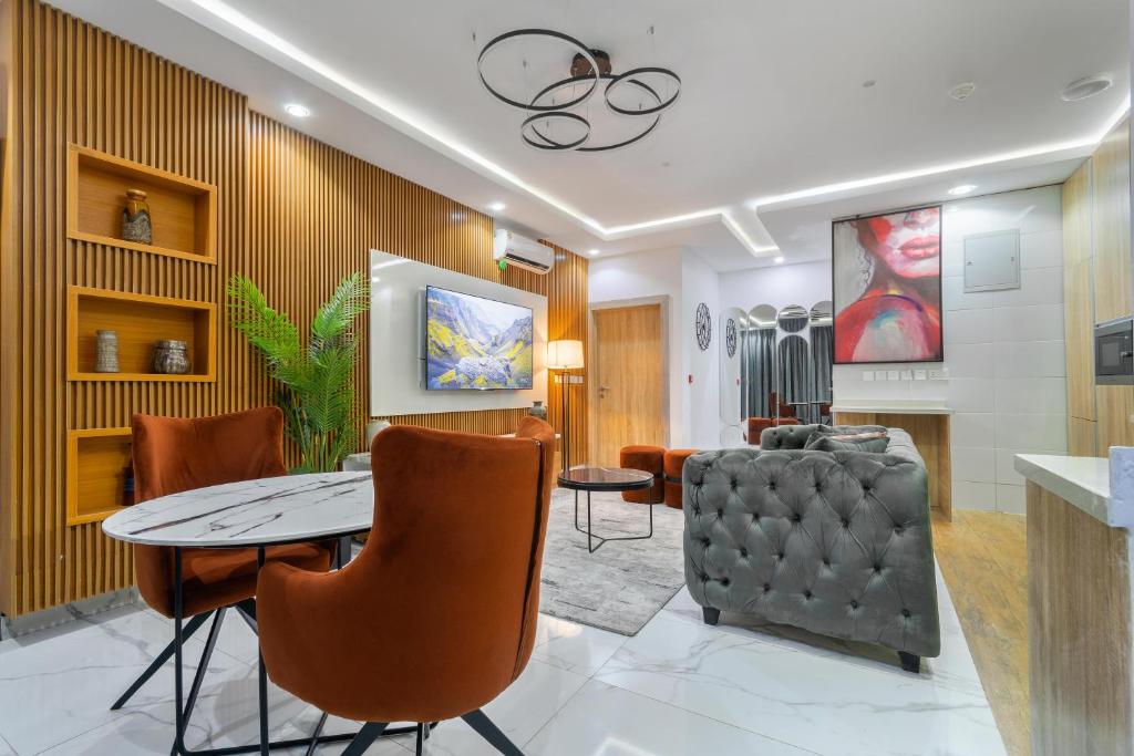 a living room with a table and a chair at W16 Waterfront Apartment Lekki Phase 1 in Lekki