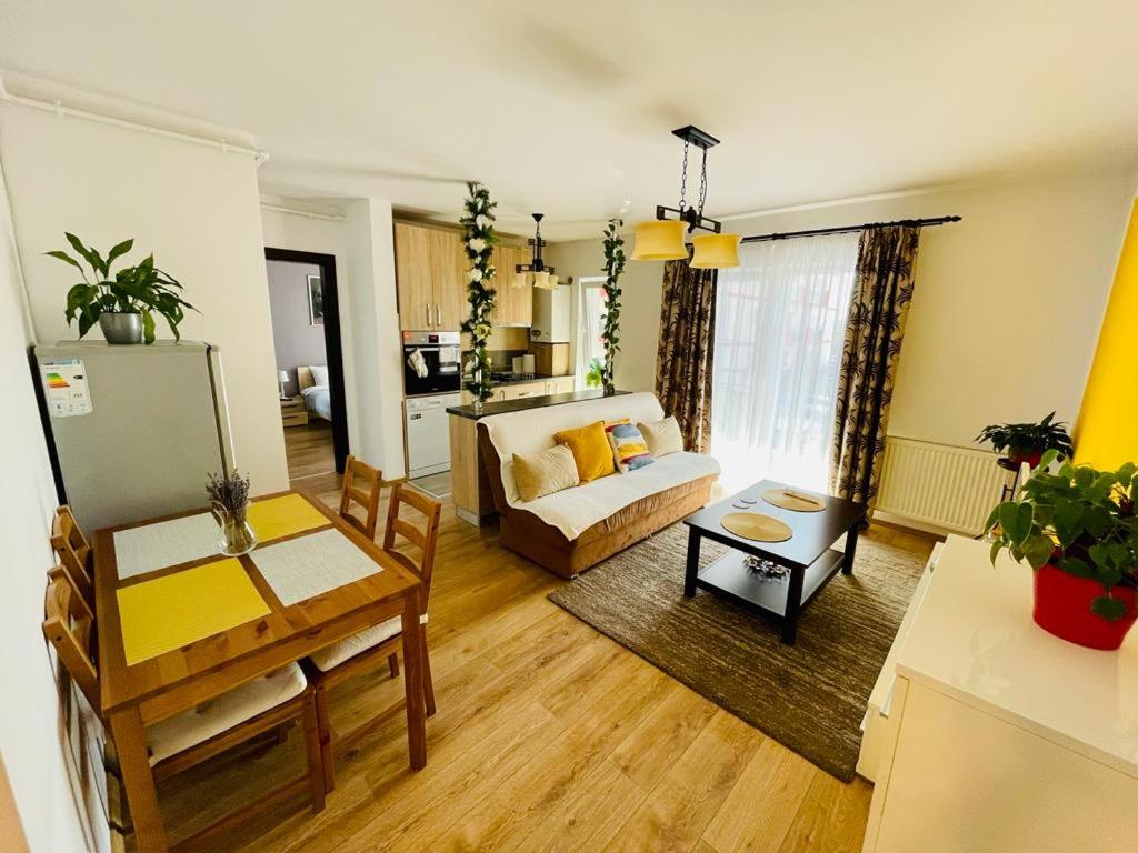 a living room with a bed and a dining room at Apartament Sofia in Sibiu