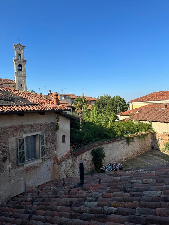 a stone building with a clock tower in the background at La tana di Piozzo in Piozzo