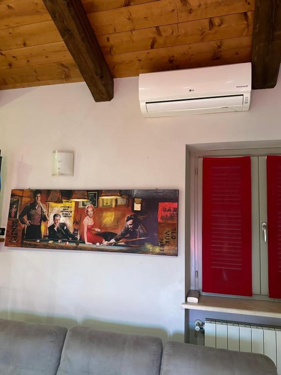 a living room with a couch and a picture on the wall at La tana di Piozzo in Piozzo