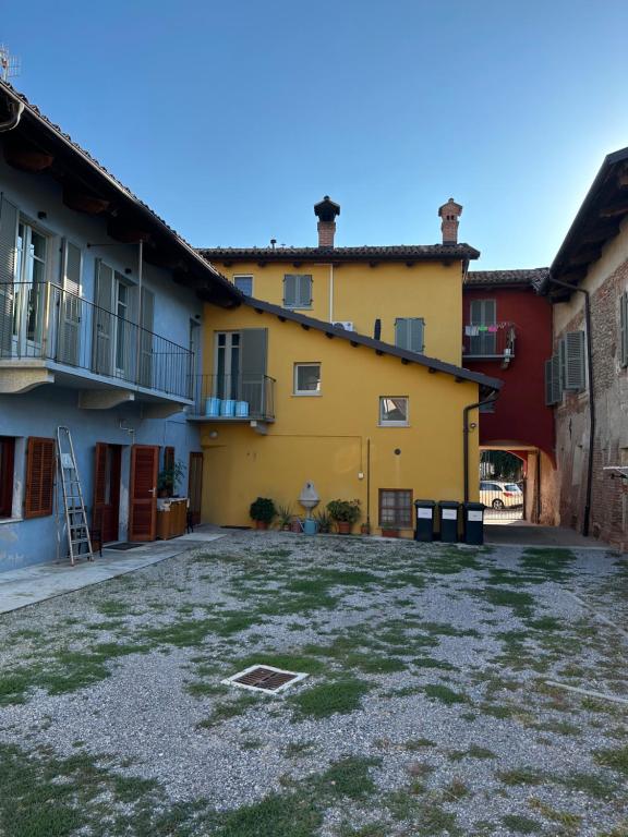 a large yard in front of a yellow building at La tana di Piozzo in Piozzo