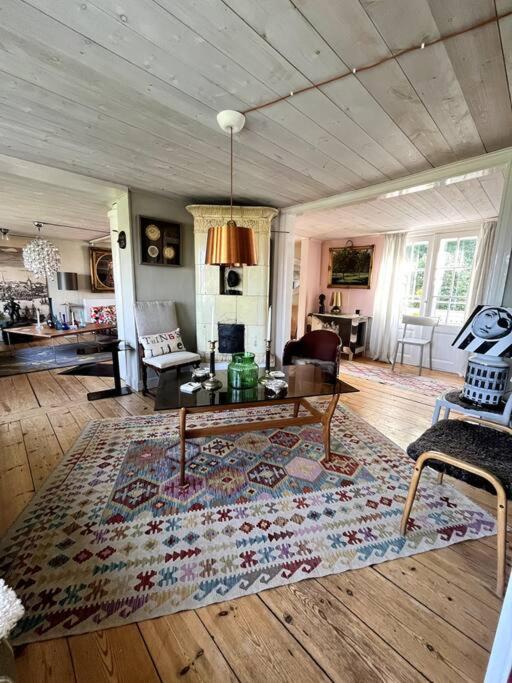 a living room with a rug on a wooden floor at Gränna Grandeur Stay in Style in Gränna