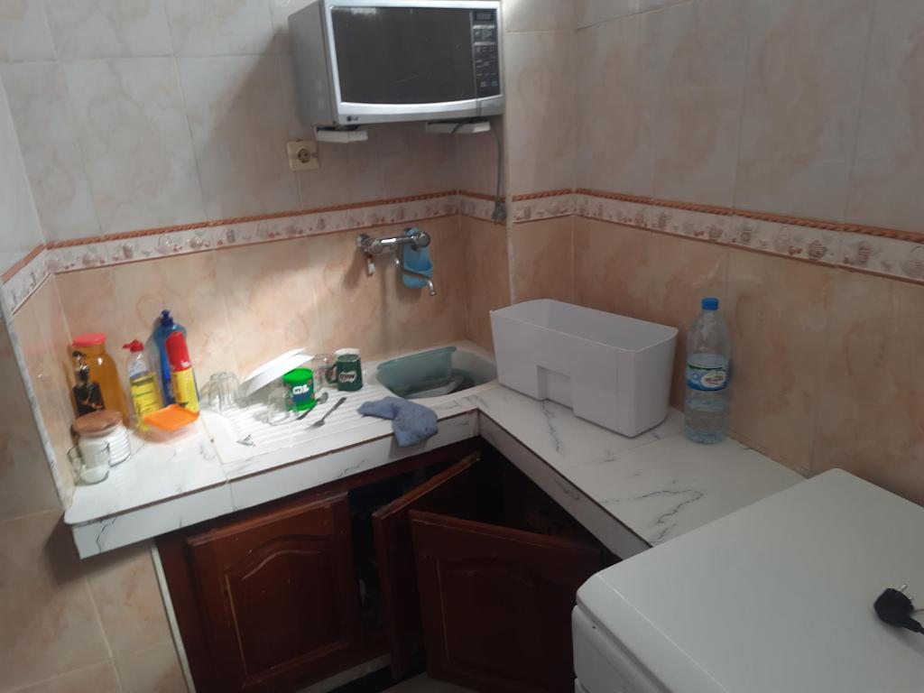 a small bathroom with a sink and a microwave at Maison familiale in Boumerdes