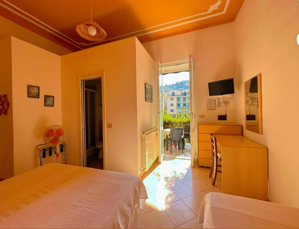 a bedroom with a bed and a desk and a table at Hotel Villa Marosa in Rapallo