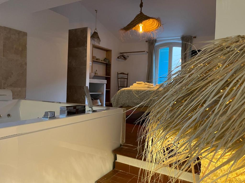 a living room with a staircase and a mirror at La Recampado in Bormes-les-Mimosas