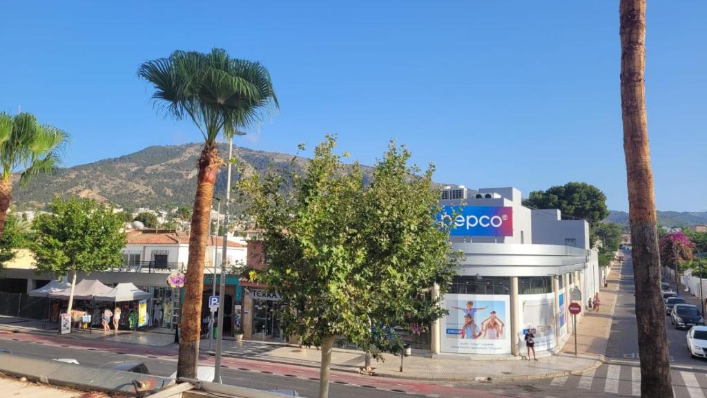 uma rua com palmeiras em frente a uma loja em Apartamento playa del Albir em Albir